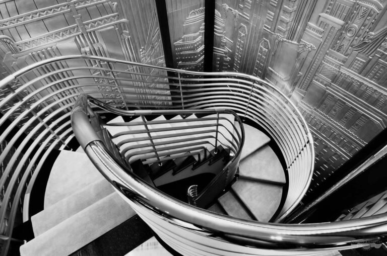 Black and white spiral staircase with Art Deco panels